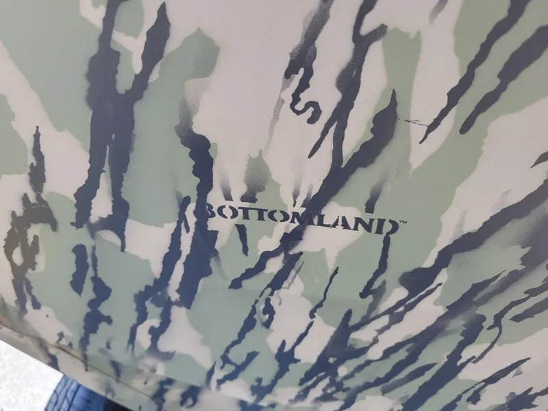 Slide: The Image of 2024 Smoker Craft Freedom 180 CC center console boat with camo pattern. - 13