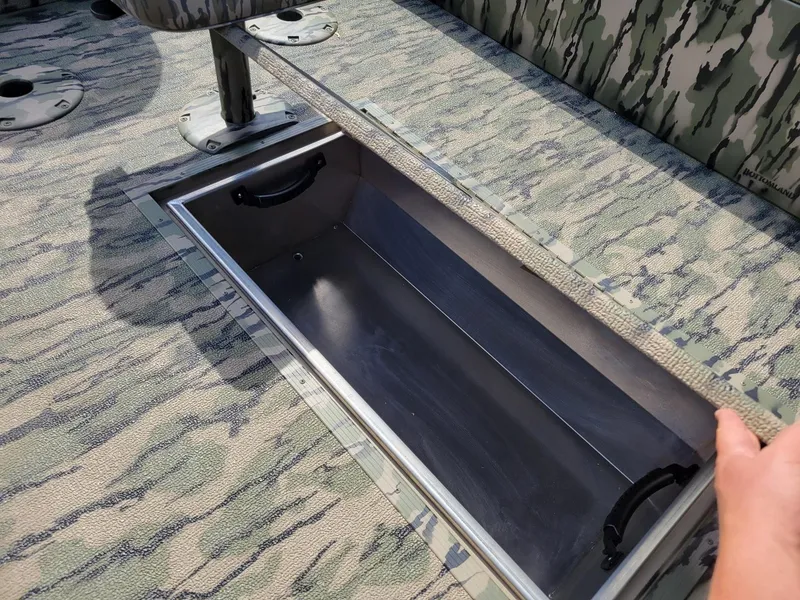 Slide: The Image of 2024 Smoker Craft Freedom 180 CC center console, camo storage compartment. - 19