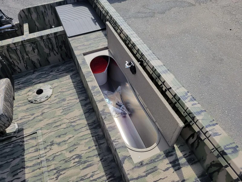 Slide: The Image of 2024 Smoker Craft Freedom 180 CC center console boat, camo design, interior storage compartment. - 20