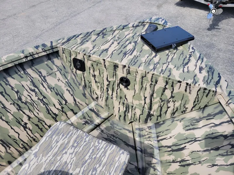 Slide: The Image of 2024 Smoker Craft Freedom 180 CC center console boat in camo pattern. - 23