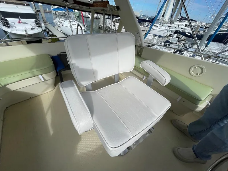 Slide: The Image of Captain's chair on 1988 Kha Shing 40 Sundeck yacht, docked at marina. - 11