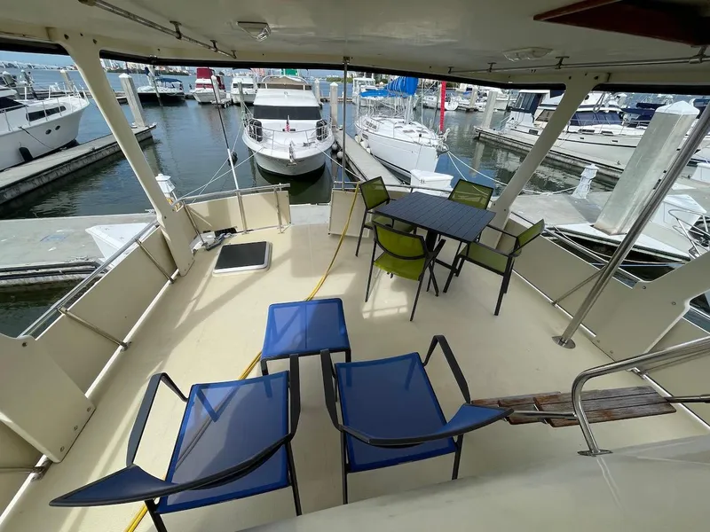 Slide: The Image of 1988 Kha Shing 40 Sundeck yacht with outdoor seating at marina. - 17