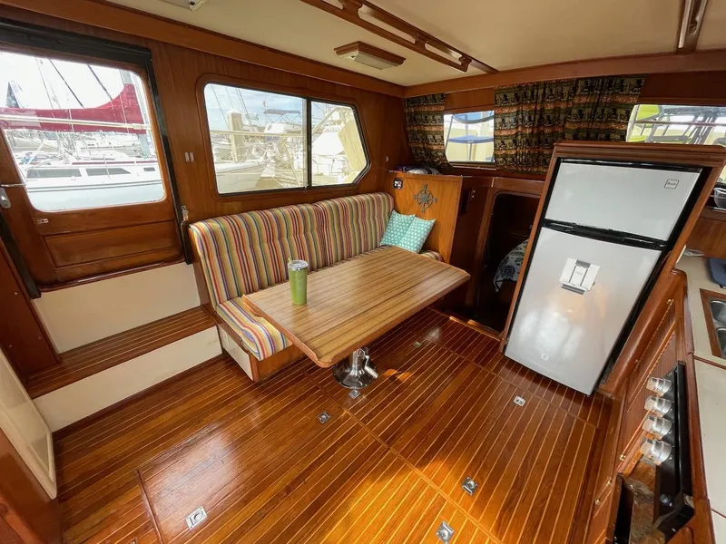 Slide: The Image of 1988 Kha Shing 40 Sundeck yacht interior with wooden flooring and dining area. - 27