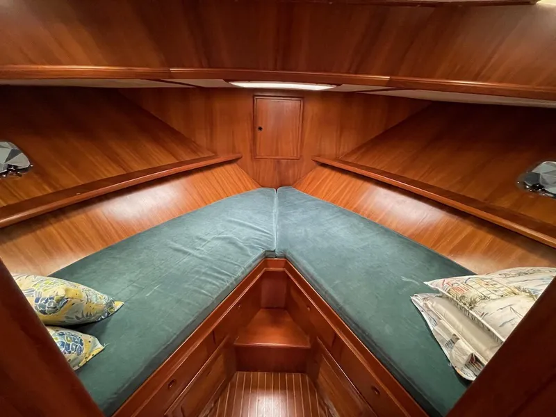 Slide: The Image of 1988 Kha Shing 40 Sundeck boat cabin with wooden interior and green bedding. - 33