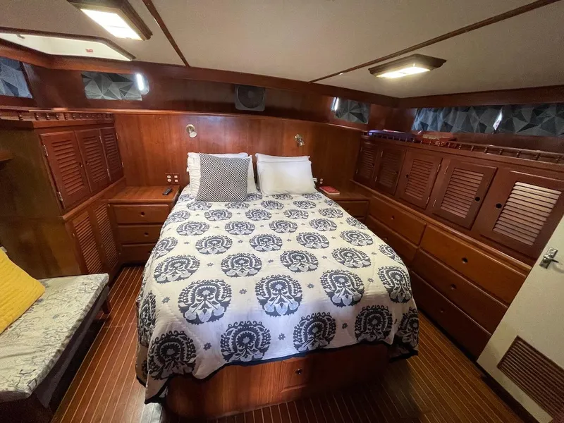 Slide: The Image of 1988 Kha Shing 40 Sundeck yacht bedroom with wooden cabinetry and patterned bedspread. - 34