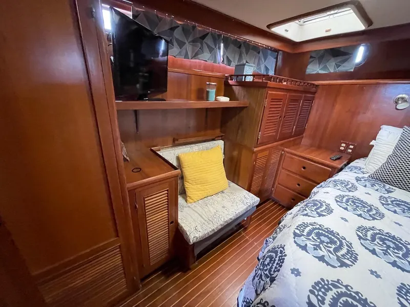 Slide: The Image of 1988 Kha Shing 40 Sundeck yacht interior with wooden cabinetry and cozy seating area. - 35