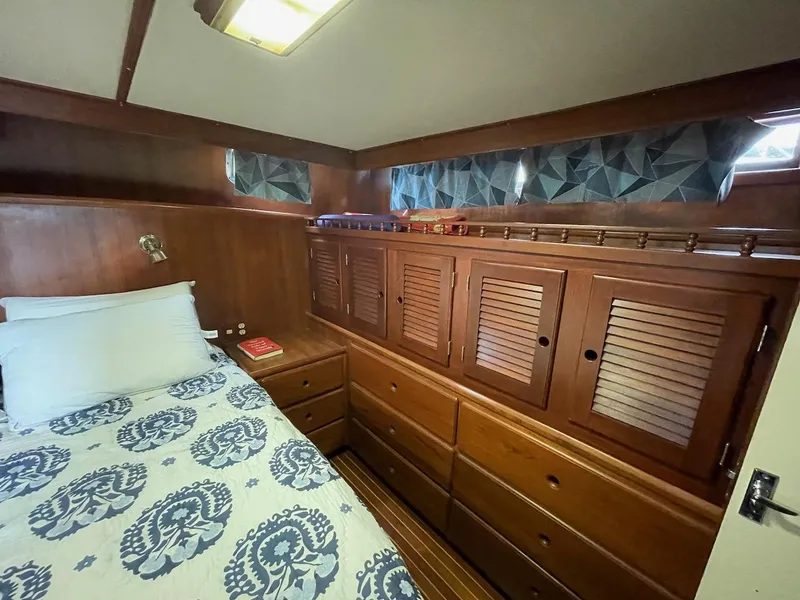 Slide: The Image of 1988 Kha Shing 40 Sundeck yacht bedroom with wooden cabinets and patterned bedding. - 36