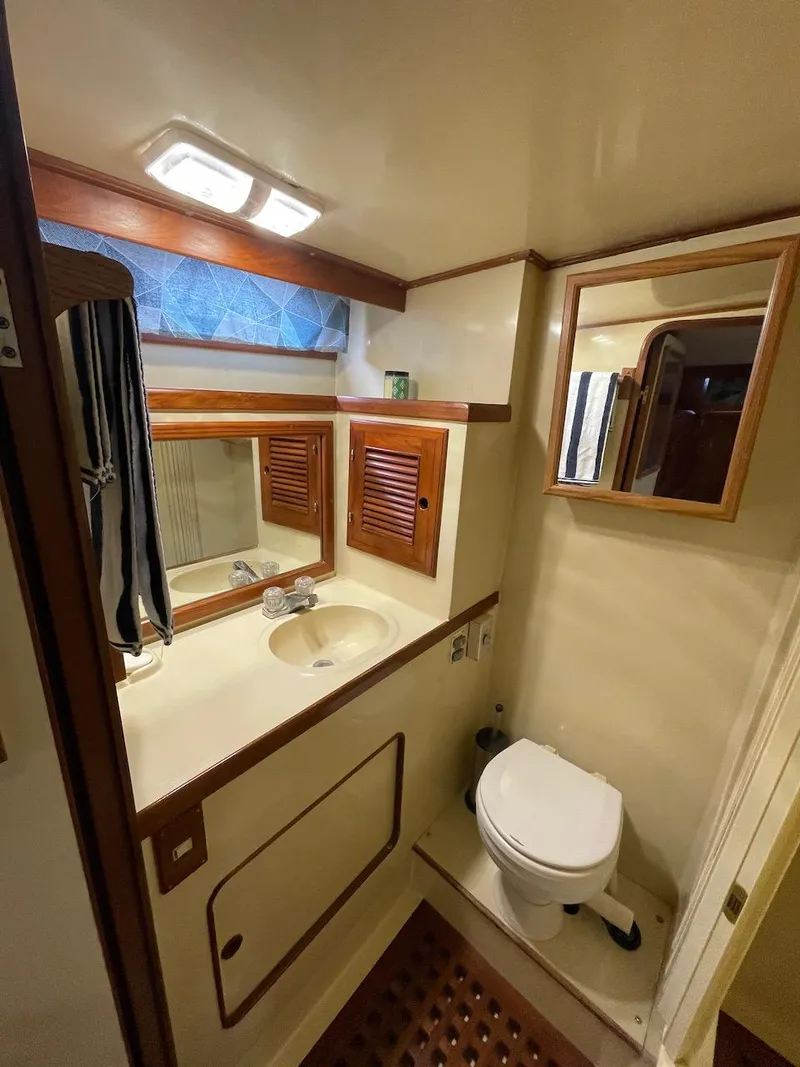 Slide: The Image of 1988 Kha Shing 40 Sundeck yacht bathroom with sink, mirror, and toilet. - 38