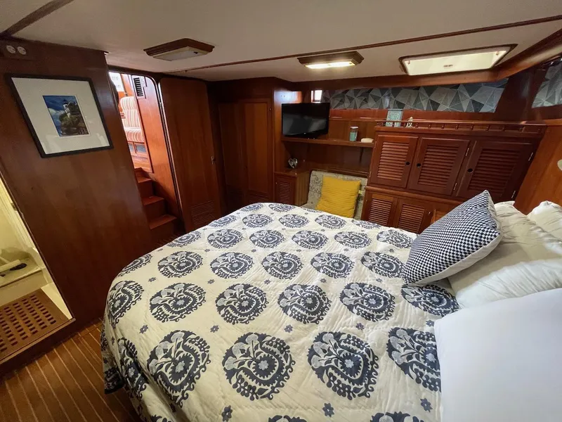 Slide: The Image of 1988 Kha Shing 40 Sundeck yacht bedroom with patterned bedding and wooden interior. - 39