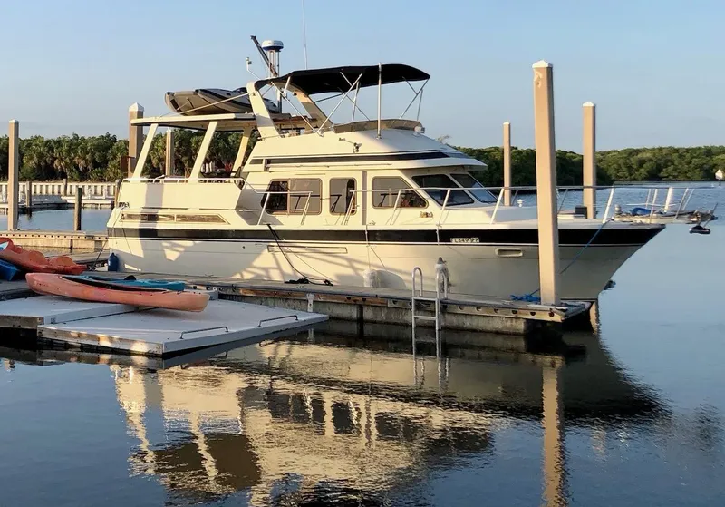 Slide: The Image of 1988 Kha Shing 40 Sundeck yacht docked at a marina. - 40