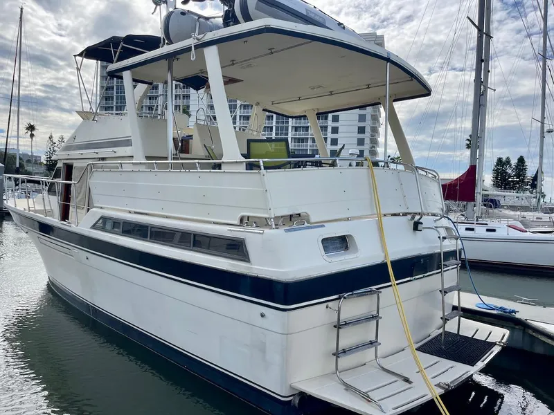 Slide: The Image of 1988 Kha Shing 40 Sundeck yacht docked at marina. - 8