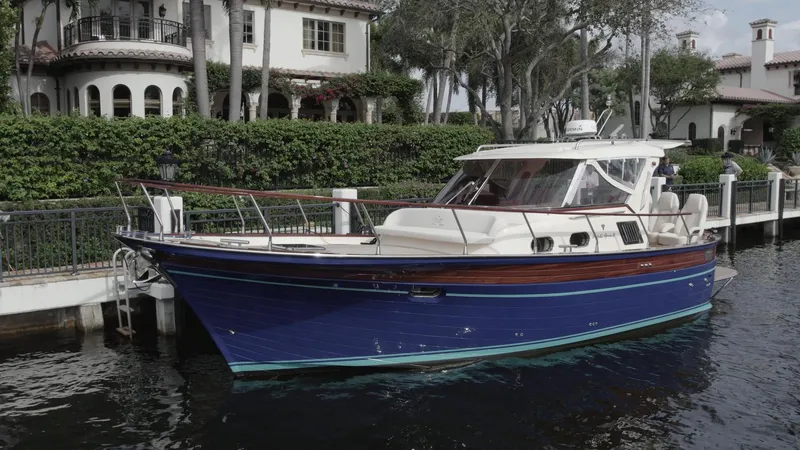 Slide: The Image of 2023 Fratelli Aprea Sorrento Cabinatto 32 docked by luxury waterfront homes. - 0