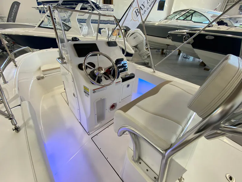 Slide: The Image of 2021 Edgewater 188 CC center console boat interior with illuminated helm station. - 2