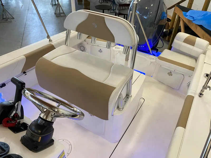 Slide: The Image of 2021 Edgewater 188 CC boat interior with helm, seating, and controls. - 3