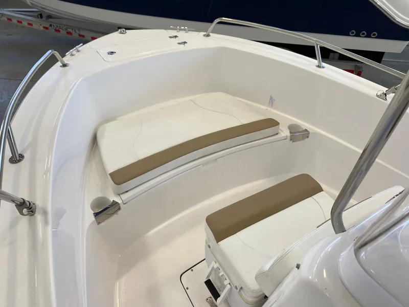 Slide: The Image of 2021 Edgewater 188 CC boat interior with cushioned seating and stainless steel railings. - 4