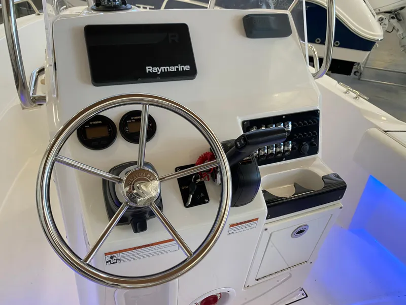 Slide: The Image of 2021 Edgewater 188 CC boat console with Raymarine electronics and steering wheel. - 6