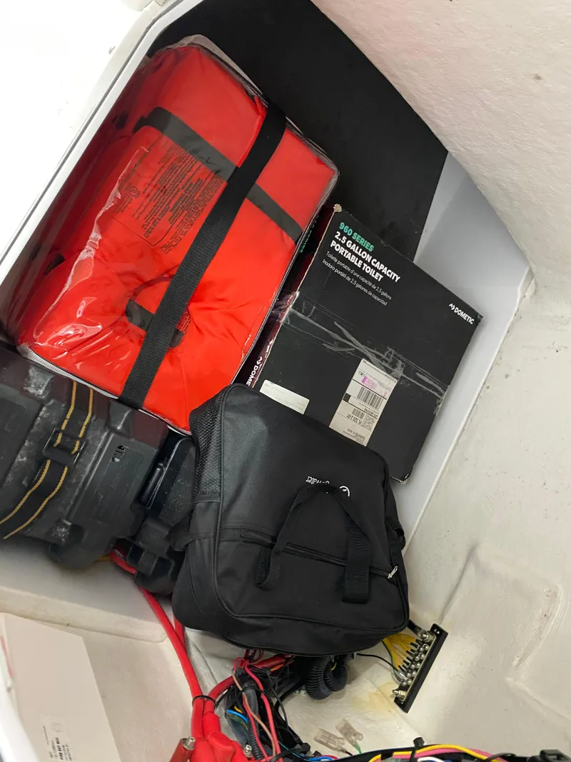 Slide: The Image of Storage compartment of a 2021 Edgewater 188 CC boat with safety gear and equipment. - 7