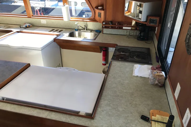 Slide: The Image of Interior kitchen of a 2008 Custom 62 Catamaran with modern amenities. - 1