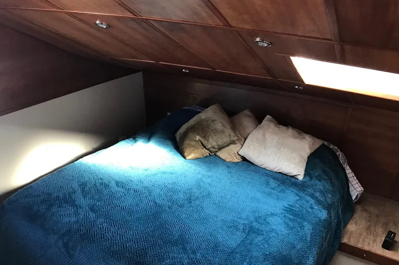 Slide: The Image of Cozy cabin bedroom with blue bedding in 2008 Custom 62 Catamaran. - 11