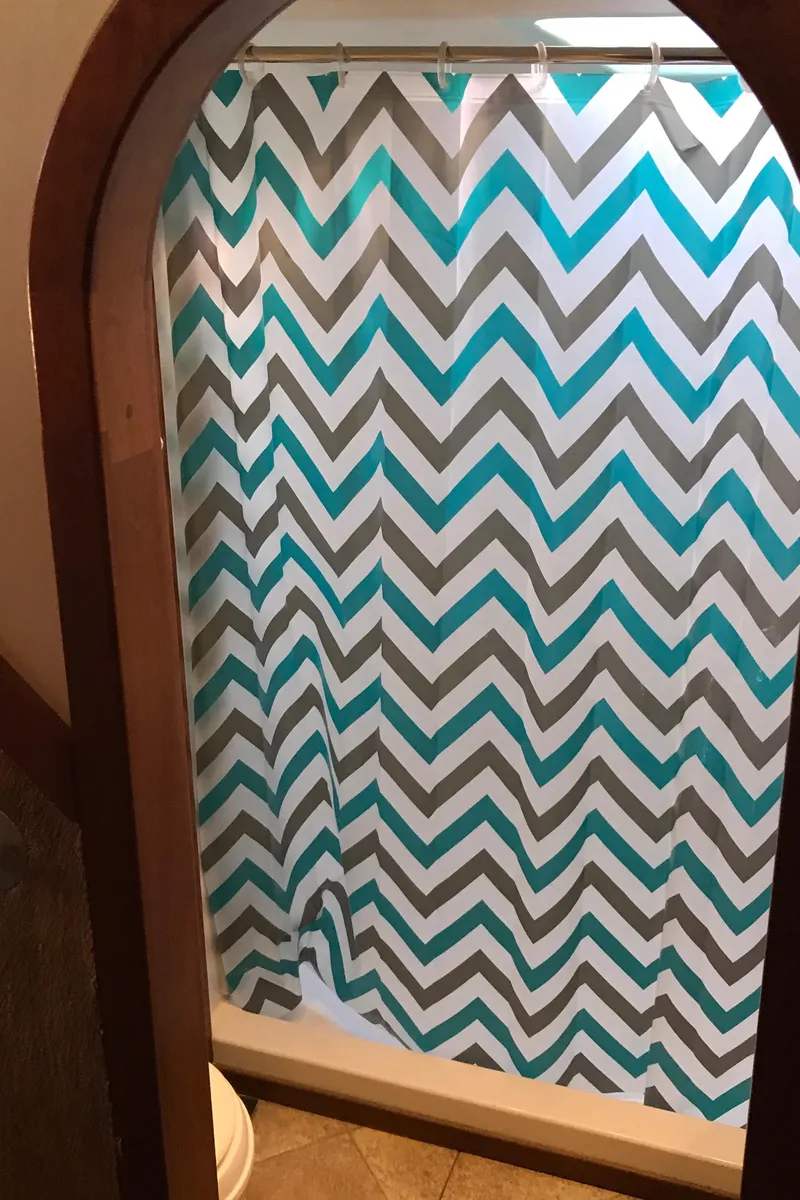 Slide: The Image of Shower area with chevron-patterned curtain on a 2008 Custom 62 Catamaran. - 14