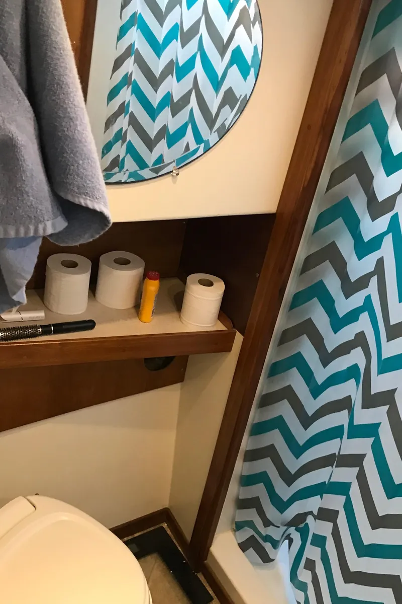 Slide: The Image of Bathroom in 2008 Custom 62 Catamaran with chevron shower curtain and round mirror. - 16