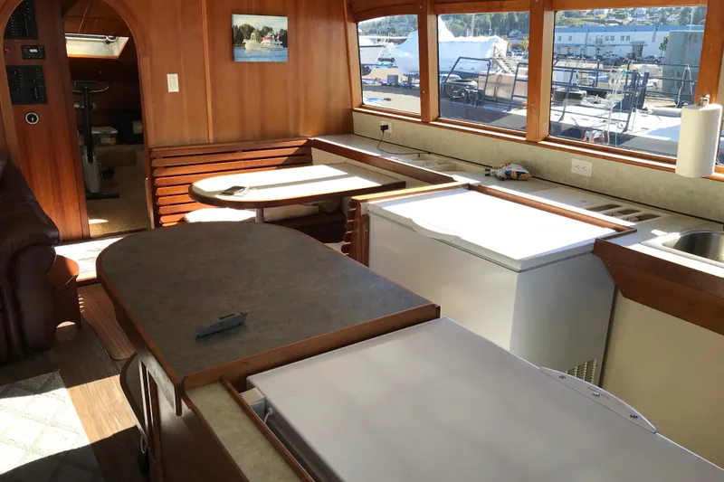 Slide: The Image of Interior of 2008 Custom 62 Catamaran with wooden finishes and large windows. - 2