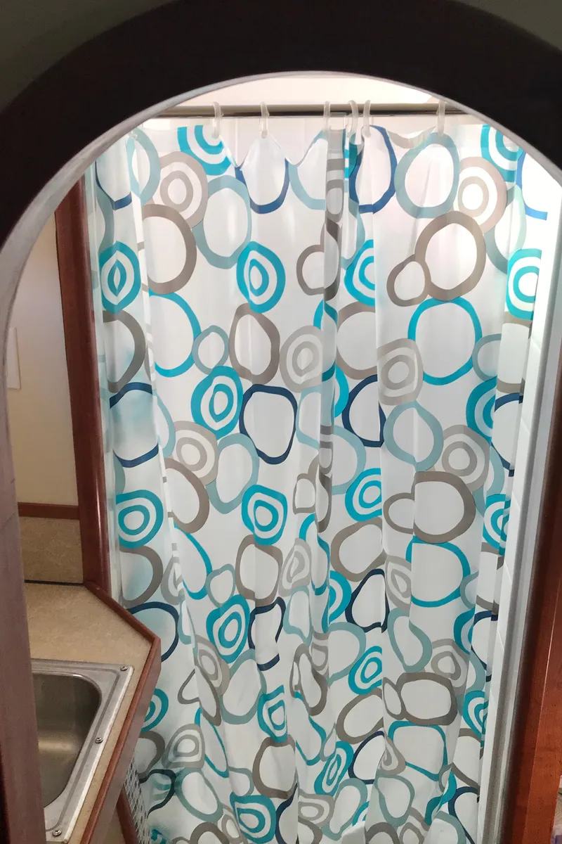 Slide: The Image of Shower area in 2008 Custom 62 Catamaran with colorful circular-patterned curtain. - 20