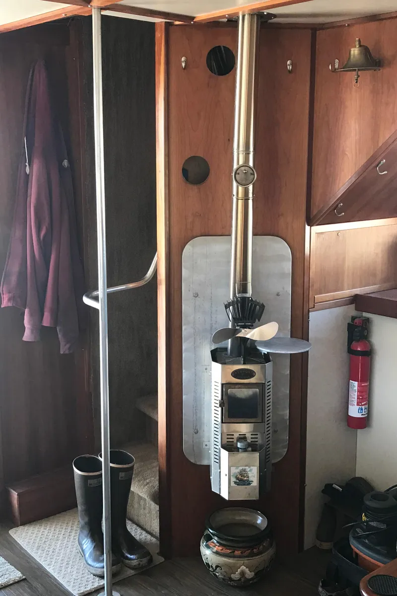 Slide: The Image of Interior of a 2008 Custom 62 Catamaran with a wood stove and nautical decor. - 22