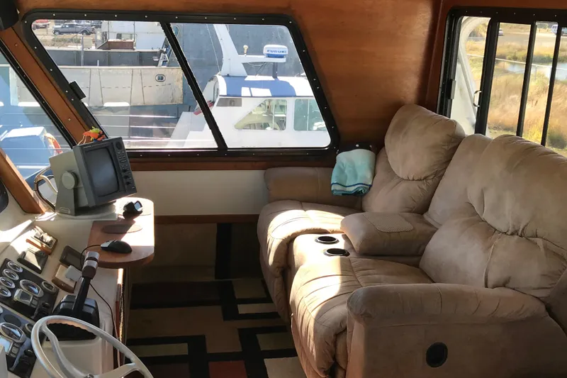 Slide: The Image of Luxurious interior of a 2008 Custom 62 Catamaran with plush seating and navigation equipment. - 23