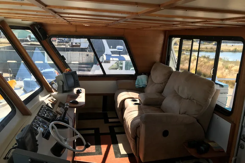 Slide: The Image of Interior of a 2008 Custom 62 Catamaran with plush seating and navigational equipment. - 25