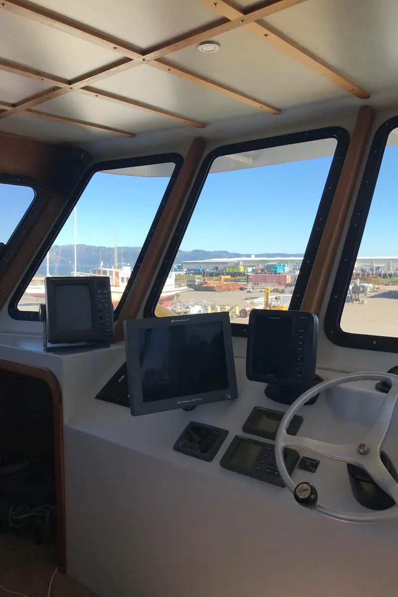 Slide: The Image of Interior view of 2008 Custom 62 Catamaran cockpit with navigation equipment and panoramic windows. - 27