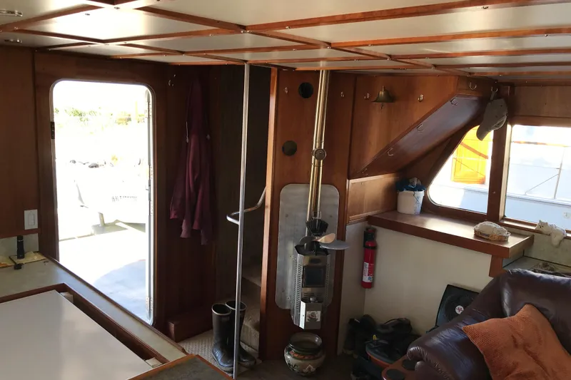 Slide: The Image of Interior of a 2008 Custom 62 Catamaran with wooden paneling and cozy seating area. - 3