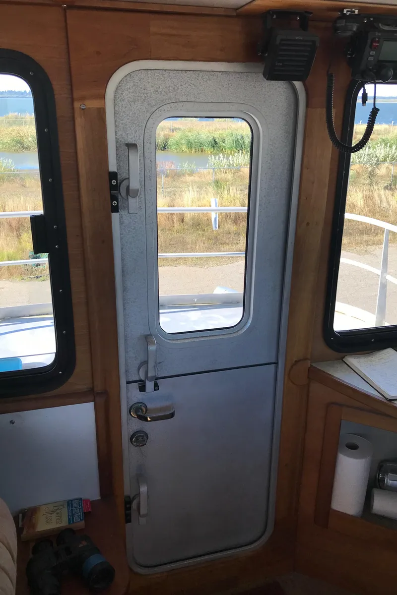 Slide: The Image of Interior view of a 2008 Custom 62 Catamaran door with window and outdoor scenery. - 31