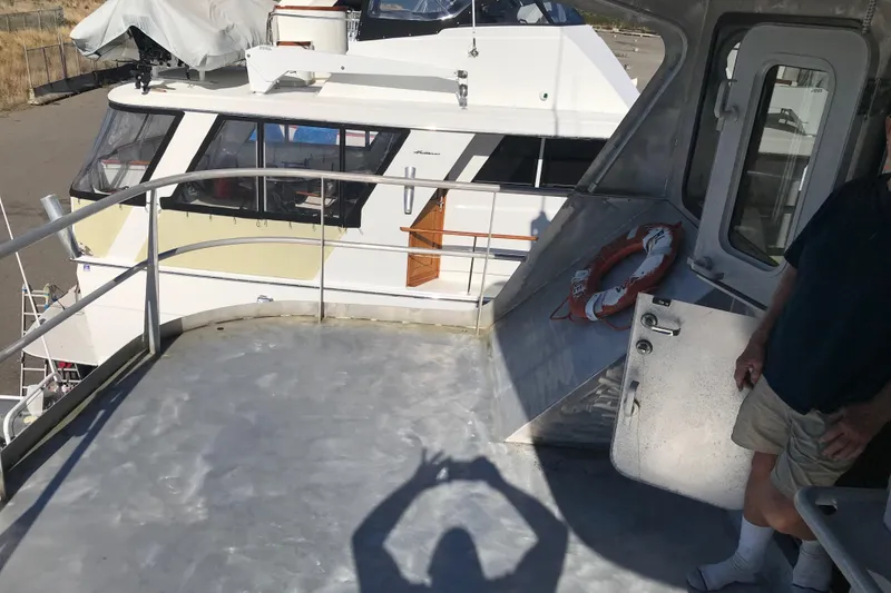 Slide: The Image of 2008 Custom 62 Catamaran deck with railing and life preserver, shadow of person taking photo. - 32