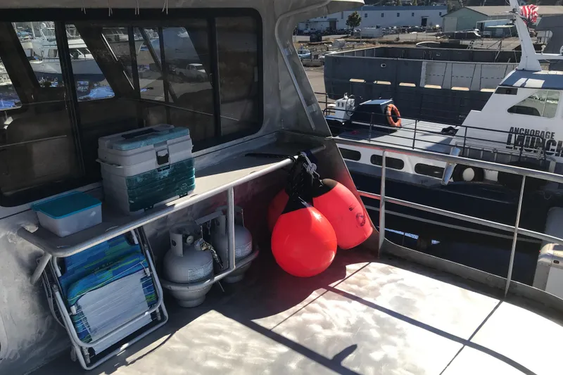 Slide: The Image of Deck of 2008 Custom 62 Catamaran with equipment and docked boats in background. - 33