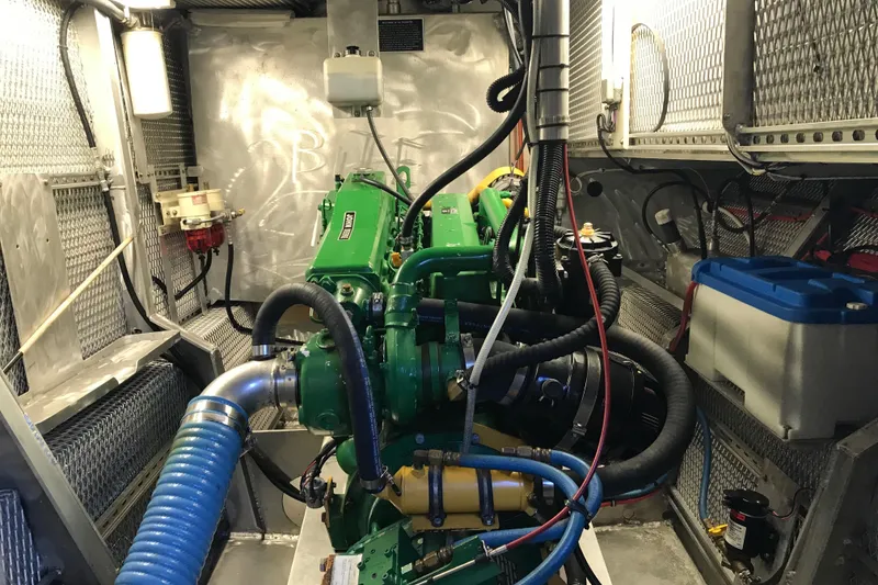 Slide: The Image of Engine room of a 2008 Custom 62 Catamaran with visible machinery and wiring. - 35