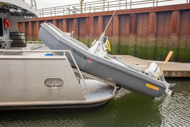 Slide: The Image of Inflatable boat on a 2008 Custom 62 Catamaran, docked at a marina. - 37