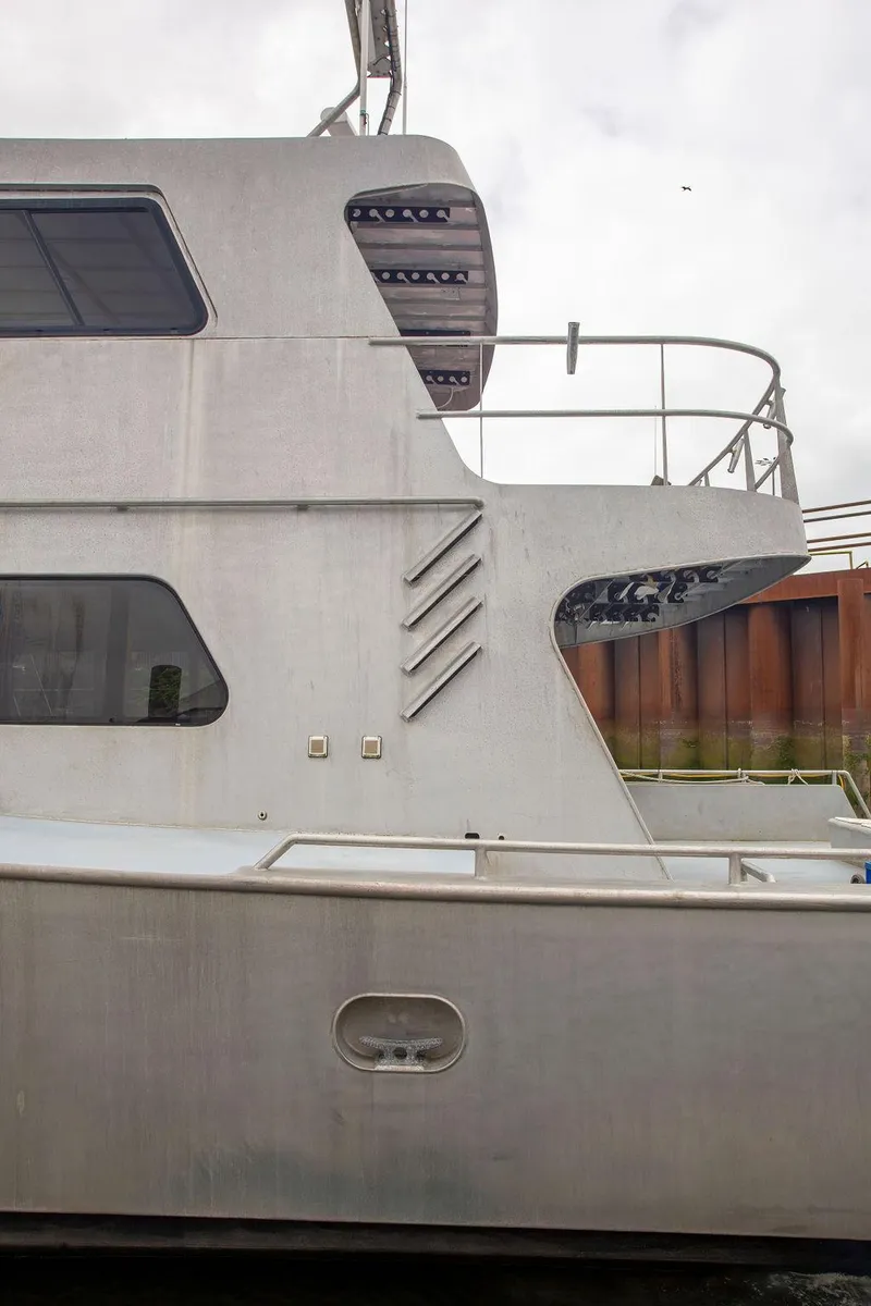 Slide: The Image of Side view of a 2008 Custom 62 Catamaran, showcasing its sleek design and modern structure. - 38