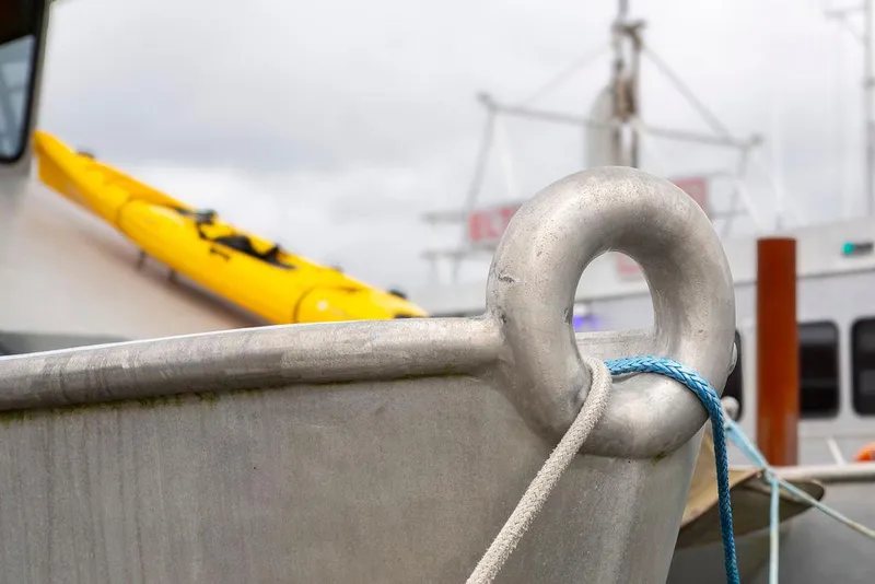 Slide: The Image of Bow of a 2008 Custom 62 Catamaran with yellow kayak and ropes. - 45