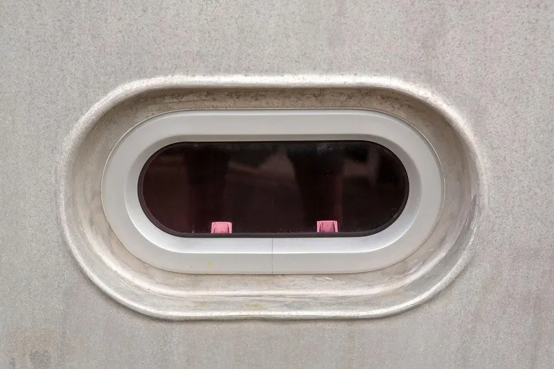 Slide: The Image of Oval window on a 2008 Custom 62 Catamaran. - 46