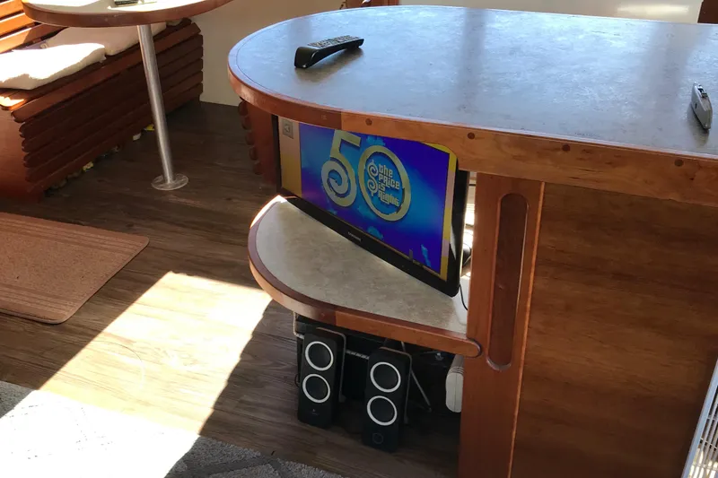 Slide: The Image of Interior of a 2008 Custom 62 Catamaran with TV and speakers on wooden furniture. - 5