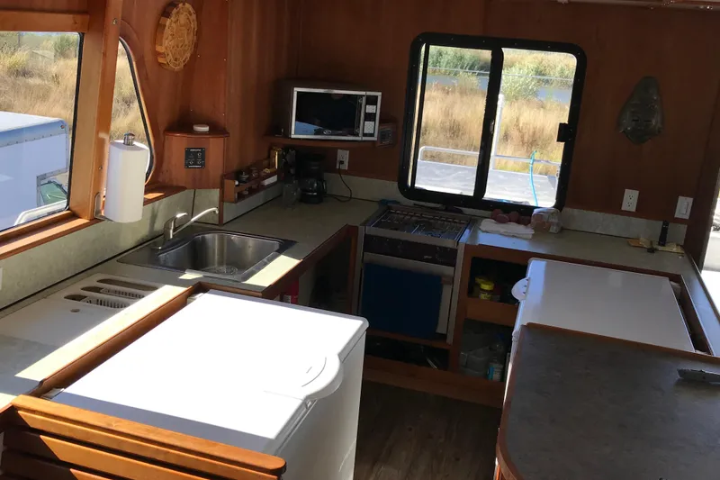 Slide: The Image of Interior of 2008 Custom 62 Catamaran kitchen with appliances and wooden cabinetry. - 6
