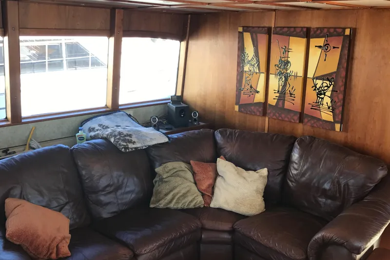 Slide: The Image of Luxurious 2008 Custom 62 Catamaran interior with leather sofa and decorative wall art. - 8