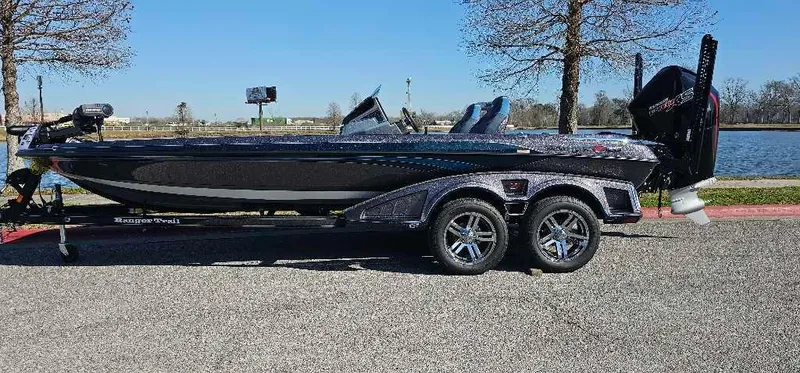Slide: The Image of 2024 Ranger Z521R Ranger Cup Equipped boat parked near a lake. - 0