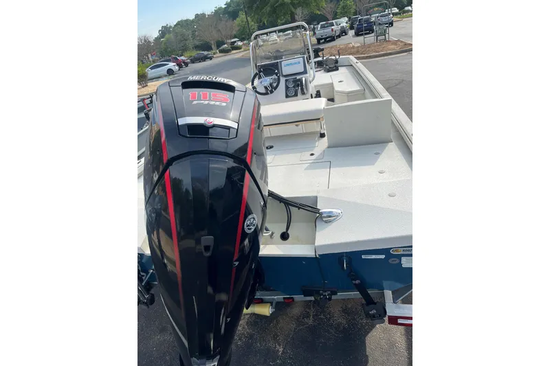 Slide: The Image of 2024 Ranger RB190 boat with Mercury 115 engine, parked outdoors. - 2