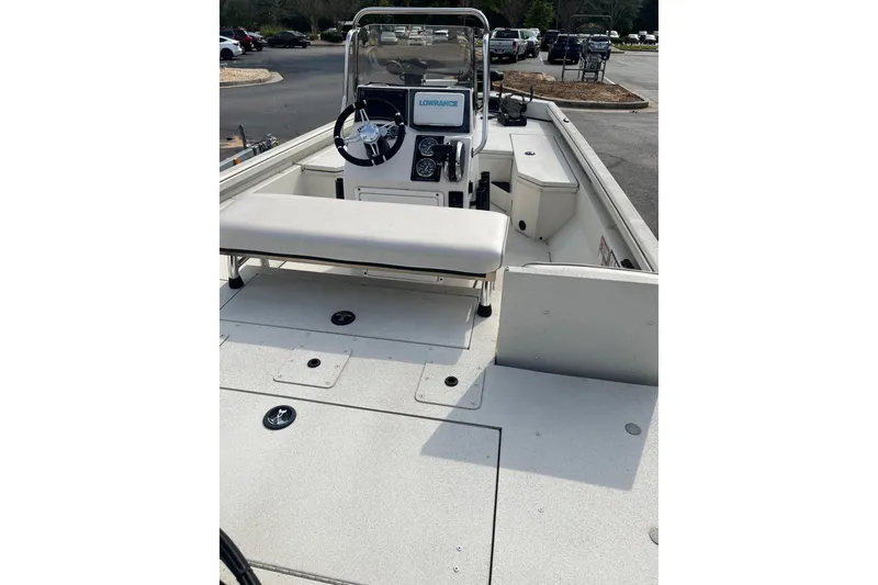 Slide: The Image of 2024 Ranger RB190 boat interior with steering console and seating in a parking lot. - 1