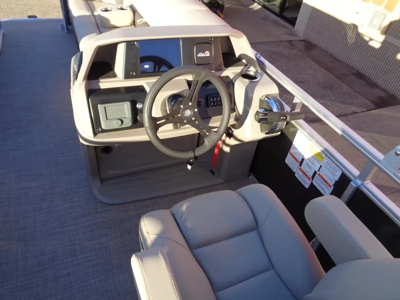 Slide: The Image of 2024 Sun Tracker Party Barge 20 DLX helm with steering wheel and control panel. - 10