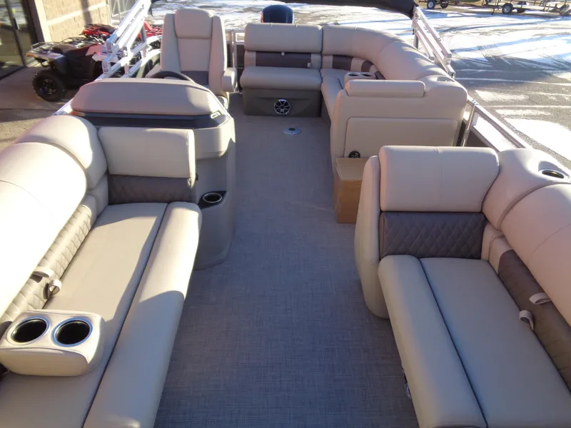 Slide: The Image of 2024 Sun Tracker Party Barge 20 DLX interior with spacious seating and cup holders. - 7