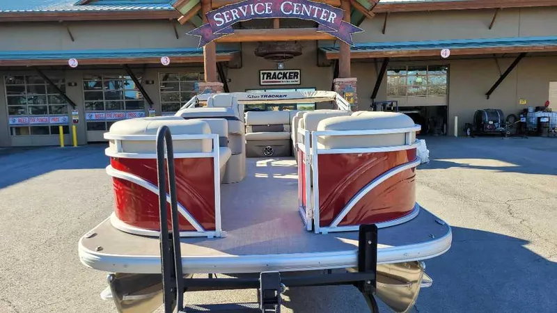 Slide: The Image of 2024 Sun Tracker Party Barge 20 DLX at service center, rear view. - 3