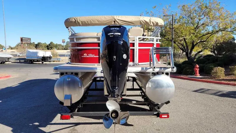 Slide: The Image of 2024 Sun Tracker Party Barge 20 DLX pontoon boat, rear view with outboard motor. - 4